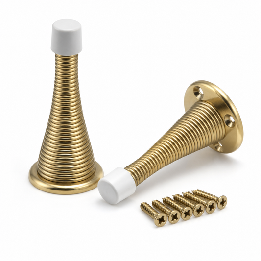 Two brass spring door stops with white protective tips